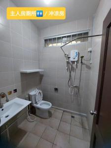 a bathroom with a shower and a toilet and a sink at Sibu wawasan no.1 Homestay in Sibu
