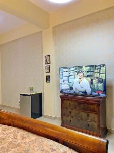 a flat screen tv sitting on top of a dresser at Green Oasis Hotel in La Romana