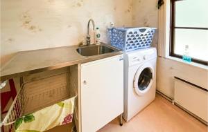 a kitchen with a sink and a washing machine at Beautiful Home In Mrdaklev With 3 Bedrooms in Mårdaklev
