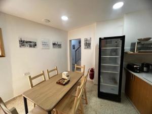 a kitchen with a wooden table and a refrigerator at William's Guest House in Jerusalem