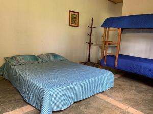 a bedroom with a bed and a bunk bed at Arte de Minas in São Gonçalo do Sapucaí
