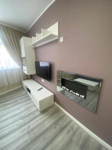 a living room with a fireplace and a tv at Jackson Holiday Apartments in Blackpool