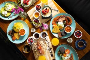 a wooden table topped with plates of breakfast food at Hayes Hotel in Thurles