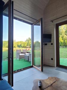 an open living room with sliding glass doors at Kemping nad stawem in Harsz
