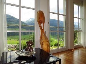 a room with a glass table and a large window at Art Appartement in Niedernsill