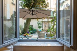 a view of a patio through a window at Il Cortile di Elisa & our flats in Lucca