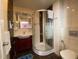 a bathroom with a shower and a sink at Finike Marina Hotel in Finike