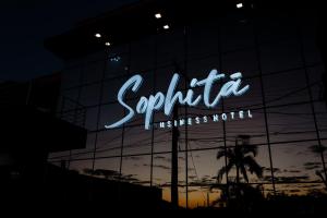 a neon sign on the side of a building at Sophita Business Hotel in Itaberá