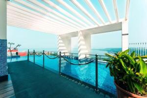 a view from the balcony of a building with a pool at A Goan Nest in Marmagao