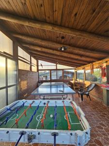 a large room with two ping pong tables at Complejo Sol in Villa Carlos Paz