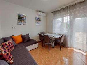 a living room with a couch and a table at Apartments Katica in Selce
