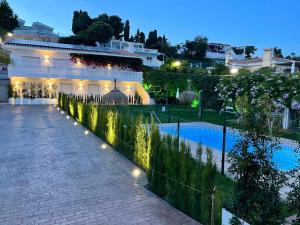 a resort with a swimming pool at night at Angeles Beach II by ELE Apartments in Vélez-Málaga
