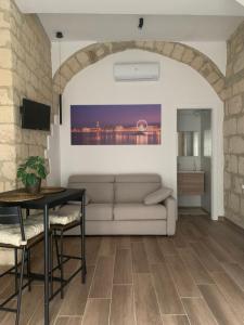 a living room with a couch and a table at La casa degli innamorati in Bari