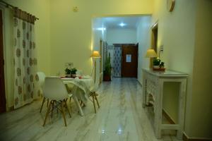 a living room with a table and chairs and a hallway at RAATREE in Mysore