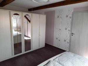 a bedroom with white cabinets and a bed in it at Harzland in Drübeck