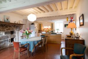 a kitchen and dining room with a table and chairs at Maison de vacances Les Mésanges, à Ménessaire in Ménessaire