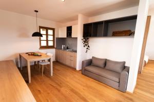 a living room with a couch and a table at Vinoteka Brda in Šmartno