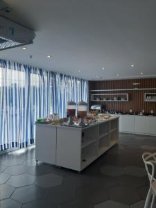a kitchen with a counter in a room with curtains at Flat Samba Bossa Nova in Cabo Frio