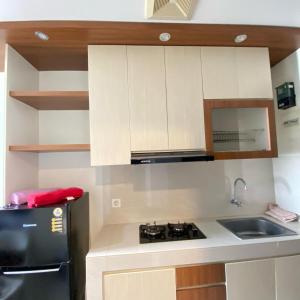 a small kitchen with a sink and a stove at Apartemen springwood in Pakulonan Dua