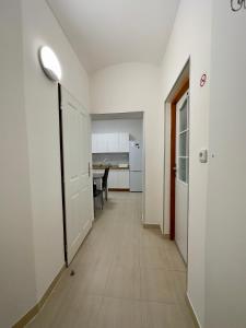 a hallway of an apartment with a door and a table at Lukas Apartments in Jáchymov
