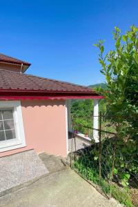 a pink house with a window and a fence at Country Home in Trabzon