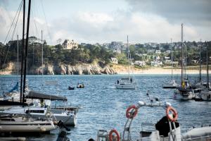 a group of boats are docked in a harbor at Le Dixmude, appartement proche plage de Morgat in Crozon