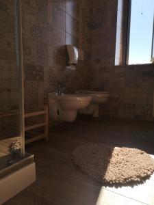 a bathroom with a sink and a toilet and a rug at Lory in Elice +48 photos