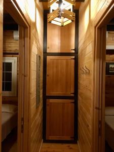 a room with a wooden door in a room at Rahoni Park & Suites in Dhërmi