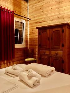 a bedroom with a bed with towels on it at Rahoni Park & Suites in Dhërmi