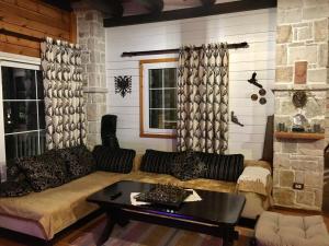 a living room with a couch and a table at Rahoni Park & Suites in Dhërmi