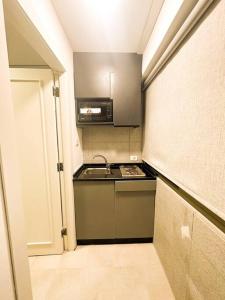 a small kitchen with a stove and a microwave at central apartment for rent 24 in Umm Uthainah