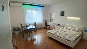 a bedroom with a bed and a table and a desk at Apartma Sonček in Ljubljana