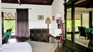 a bedroom with a bed and a dresser in a room at Quinta do Sanguinhal in Rio Maior