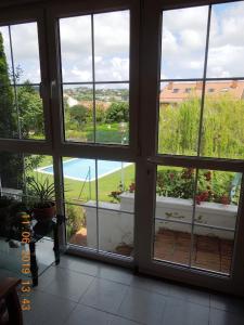 a room with a window with a view of a garden at La casa de Clara Puente Arce in Arce