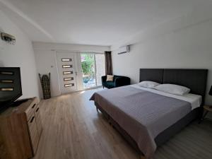 a bedroom with a bed and a television in it at A2D1 Mali Losinj in Mali Lošinj