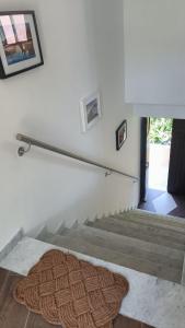 a room with stairs with a rug on the floor at Nanin's Home in Sori