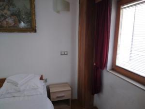 a bedroom with a bed and a window at Apartman MV in Sarajevo