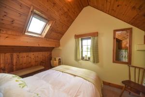 a bedroom with a bed in a room with wooden ceilings at Clays View Alstonefield in Alstonfield