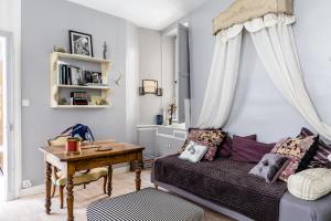 a living room with a bed and a table at Le Vintage in Périgueux