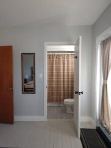 a bathroom with a toilet and a mirror at North Sea Whale House in Princeton