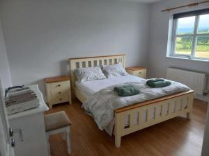 a bedroom with a bed with two green pillows on it at Buncrana Class 5 double bed in Buncrana