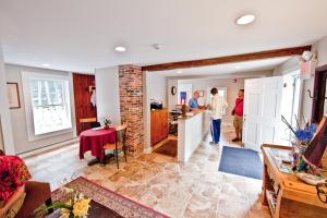 a group of people standing in a living room at Abalonia Inn in Ogunquit