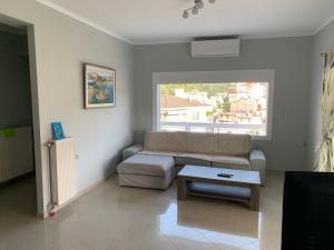 a living room with a couch and a table at Τhe Sunny Apartments in Igoumenitsa