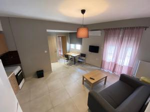 a living room with a couch and a table at Voulas suites in Eleftheroúpolis