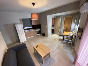 a living room with a couch and a table at Voulas suites in Eleftheroúpolis +2 photos