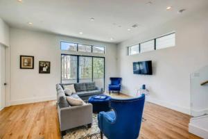 a living room with a couch and blue chairs at Two Identical 4 Story Homes Near Downtown with 8 BDRMS in Houston