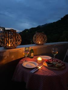 a table with wine glasses and food on a balcony at Apartments Tijana in Budva