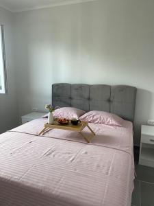 a bed with a tray on top of it at Apartments Tijana in Budva