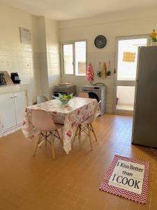 a kitchen with a table with a sign that says less better than look at Appartement: Dakar-Plateau in Dakar