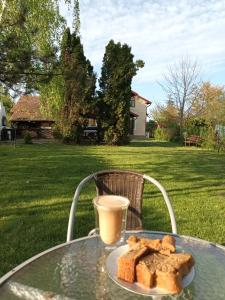 a table with a plate of bread and a cup of coffee at Argeselu Garden Villa-entire floor apartment, exclusive garden access in Mărăcineni